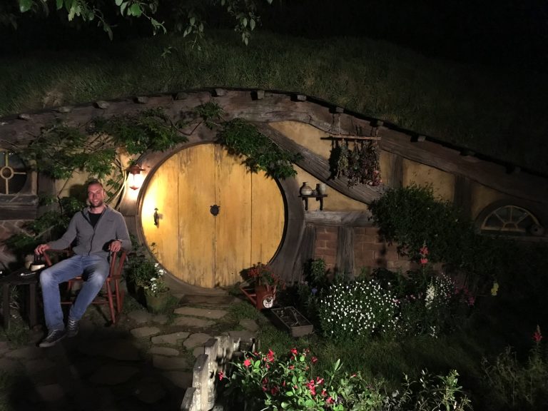 Me in front of a Hobbit house at night